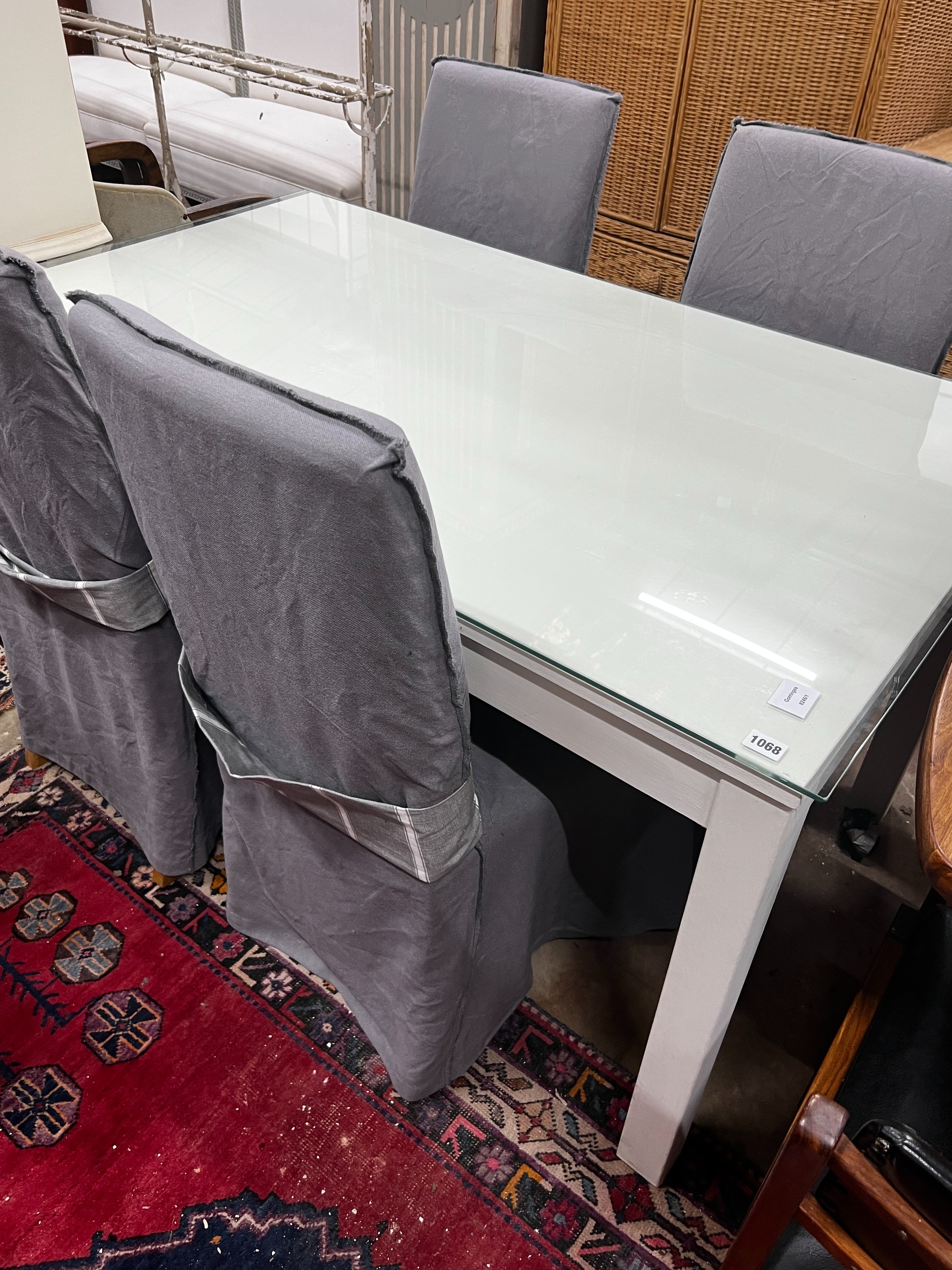 A contemporary rectangular dining table, length 140cm, width 84cm, height 75cm and four linen covered chairs